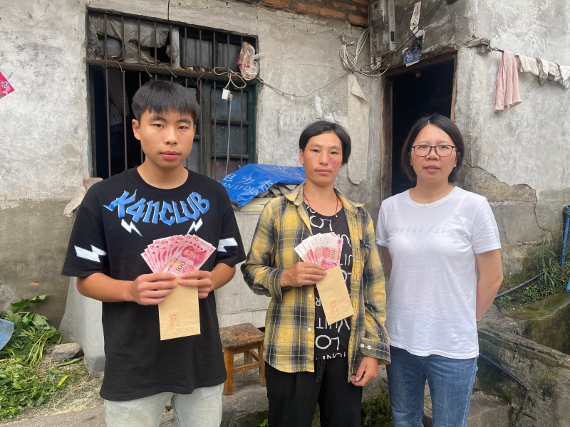 乡政府工作人员将李仕碧的爱心送到被资助学生手里.jpg